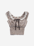 Plaid crop top with ruffled details on a white background